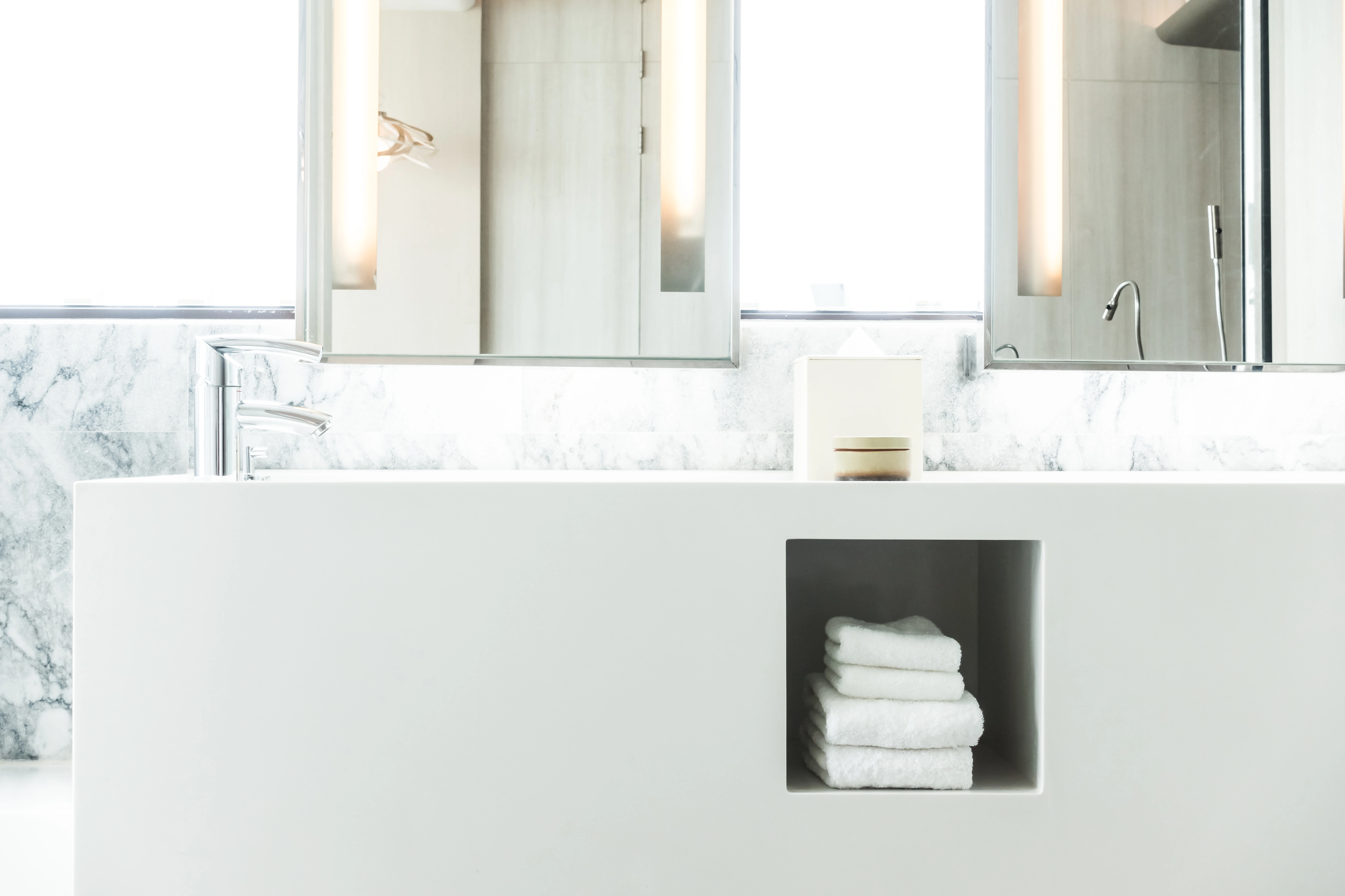 White porcelain sink with fresh towels